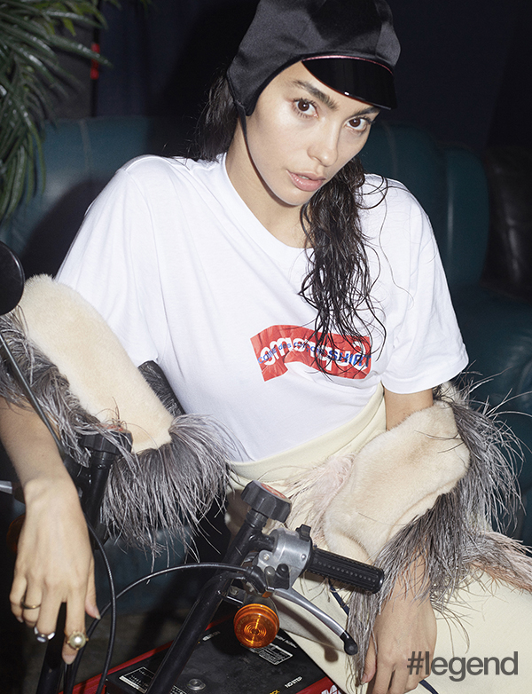 Hat by Gucci, t-shirt by Supreme, skirt and shawl by Prada, shoes by Miu Miu, rings by Dior